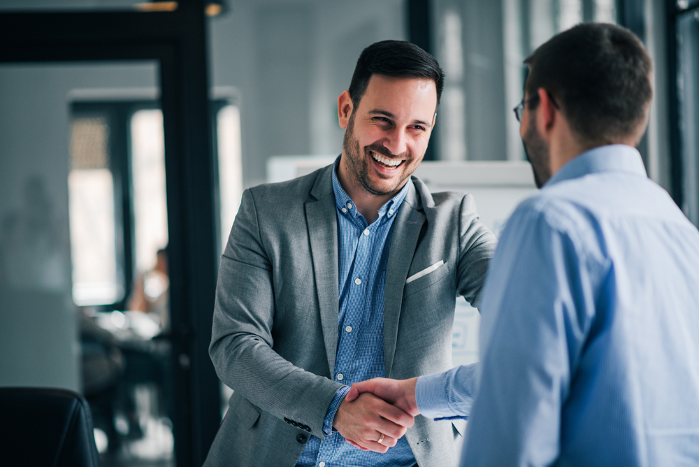 Portrait,Of,Cheerful,Young,Manager,Handshake,With,New,Employee.