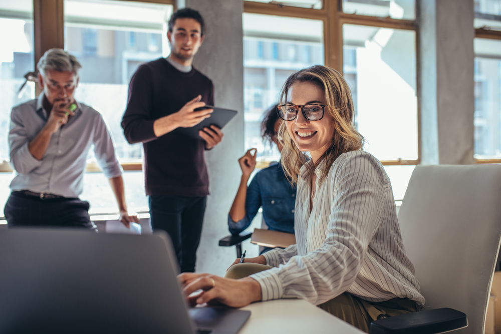 Female,Entrepreneur,Working,On,Laptop,And,Explaining,Strategy,To,Attract
